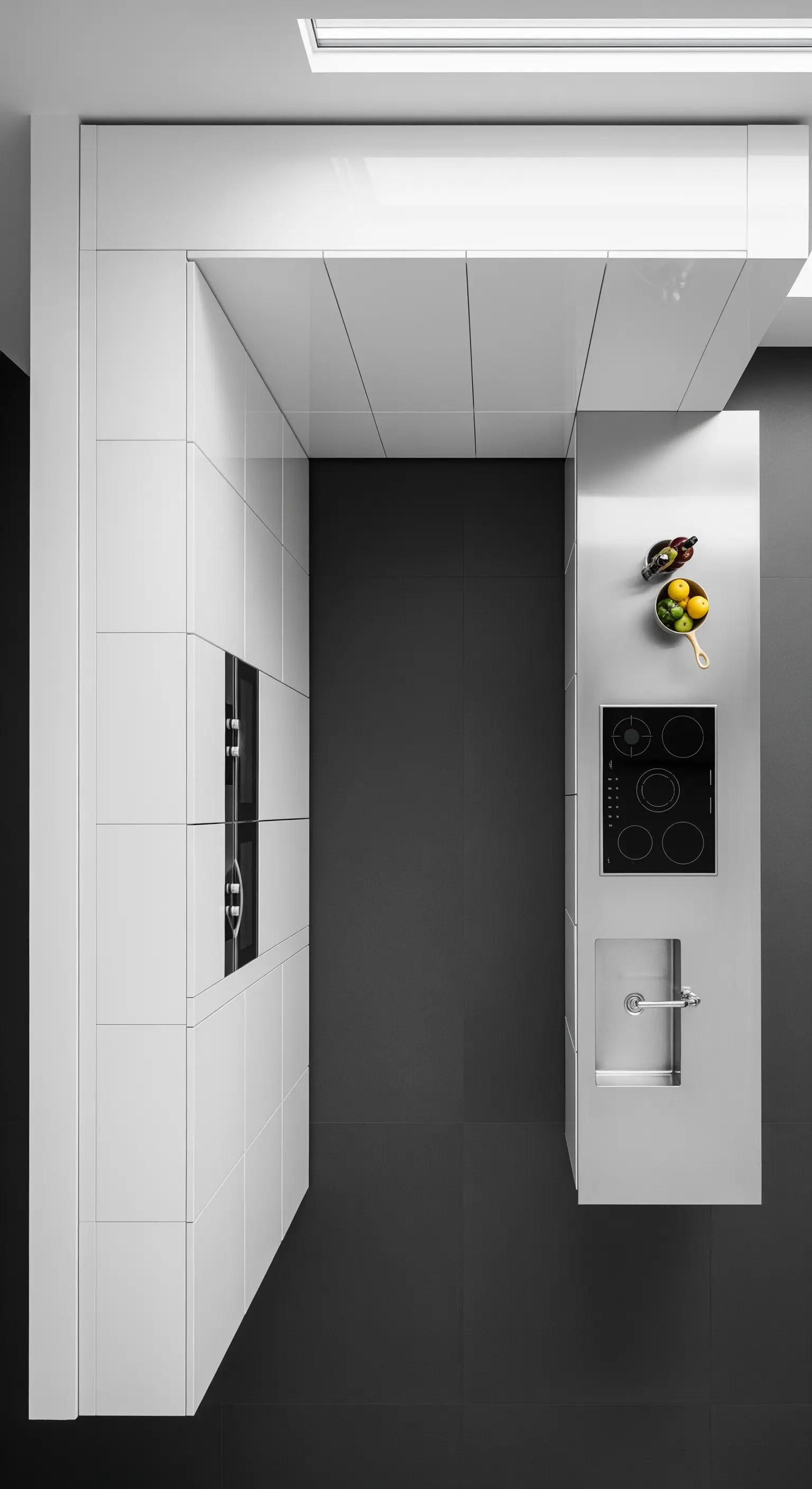 Vista dall'alto di una cucina minimalista bianca e nera a forma di L.
