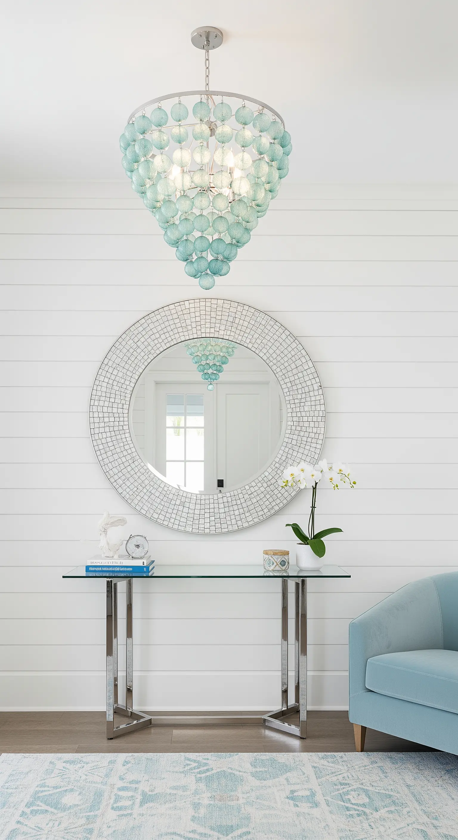 Ingresso in stile coastal con pareti a perline, specchio a mosaico e poltrona azzurra