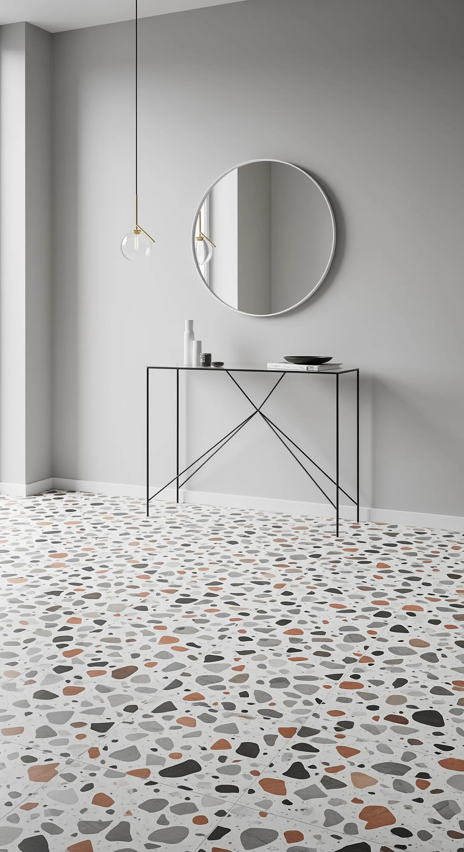 Ingresso minimalista con pavimento in terrazzo colorato e consolle esile in metallo nero.