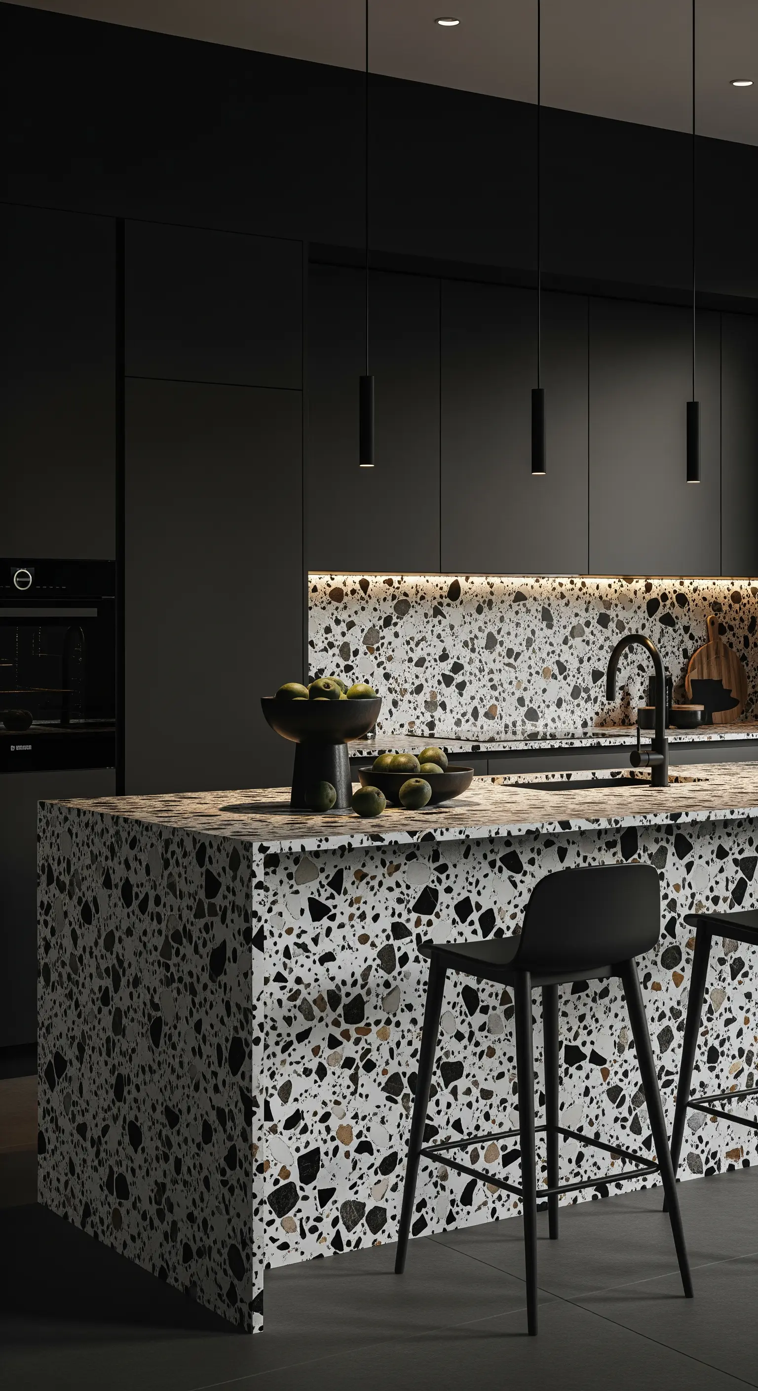 Isola e paraschizzi della cucina rivestiti in terrazzo con scaglie bianche e nere.