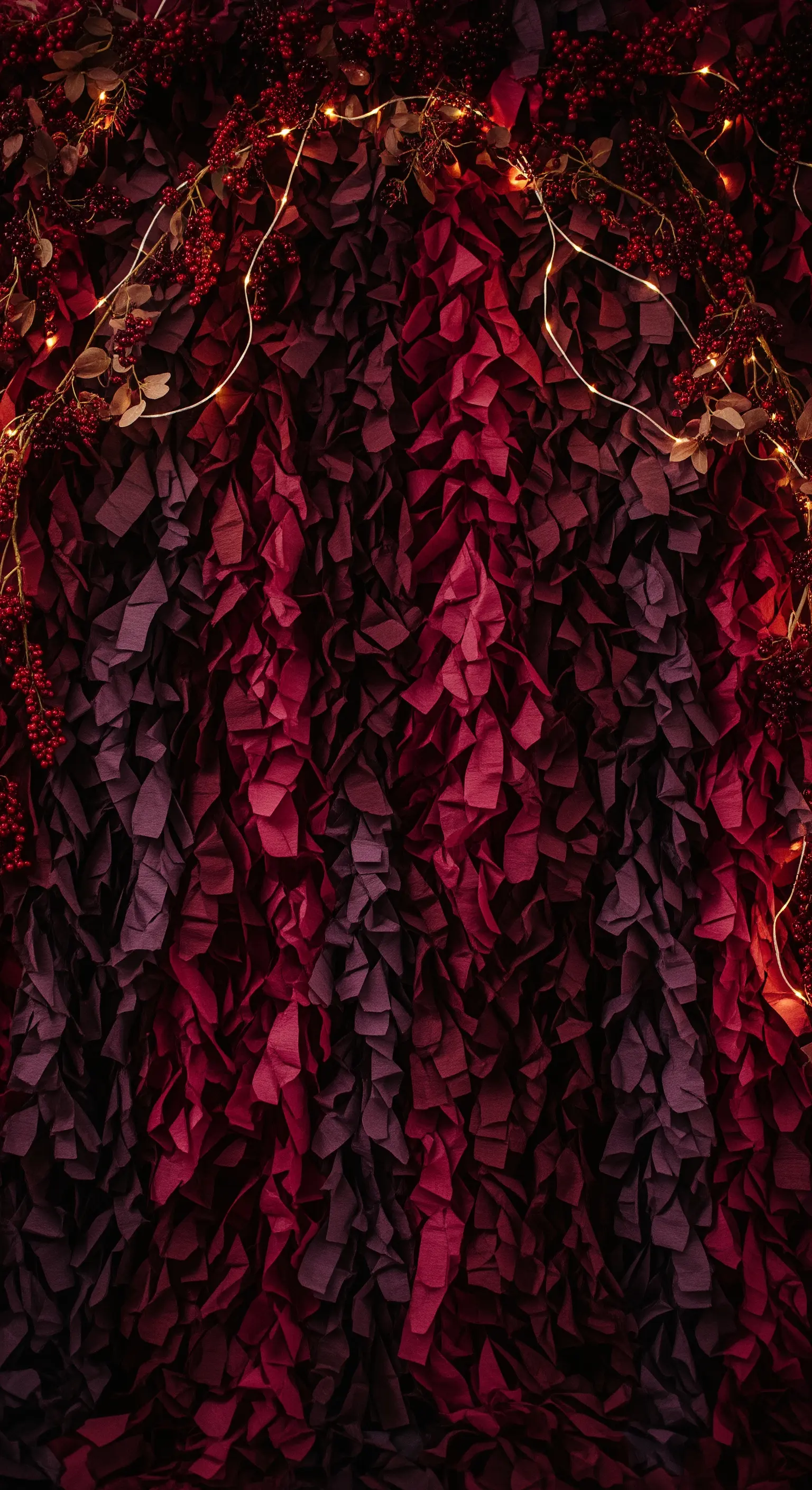 Fondale materico creato con pezzi di carta crespa rossa e viola, incorniciato da lucine.