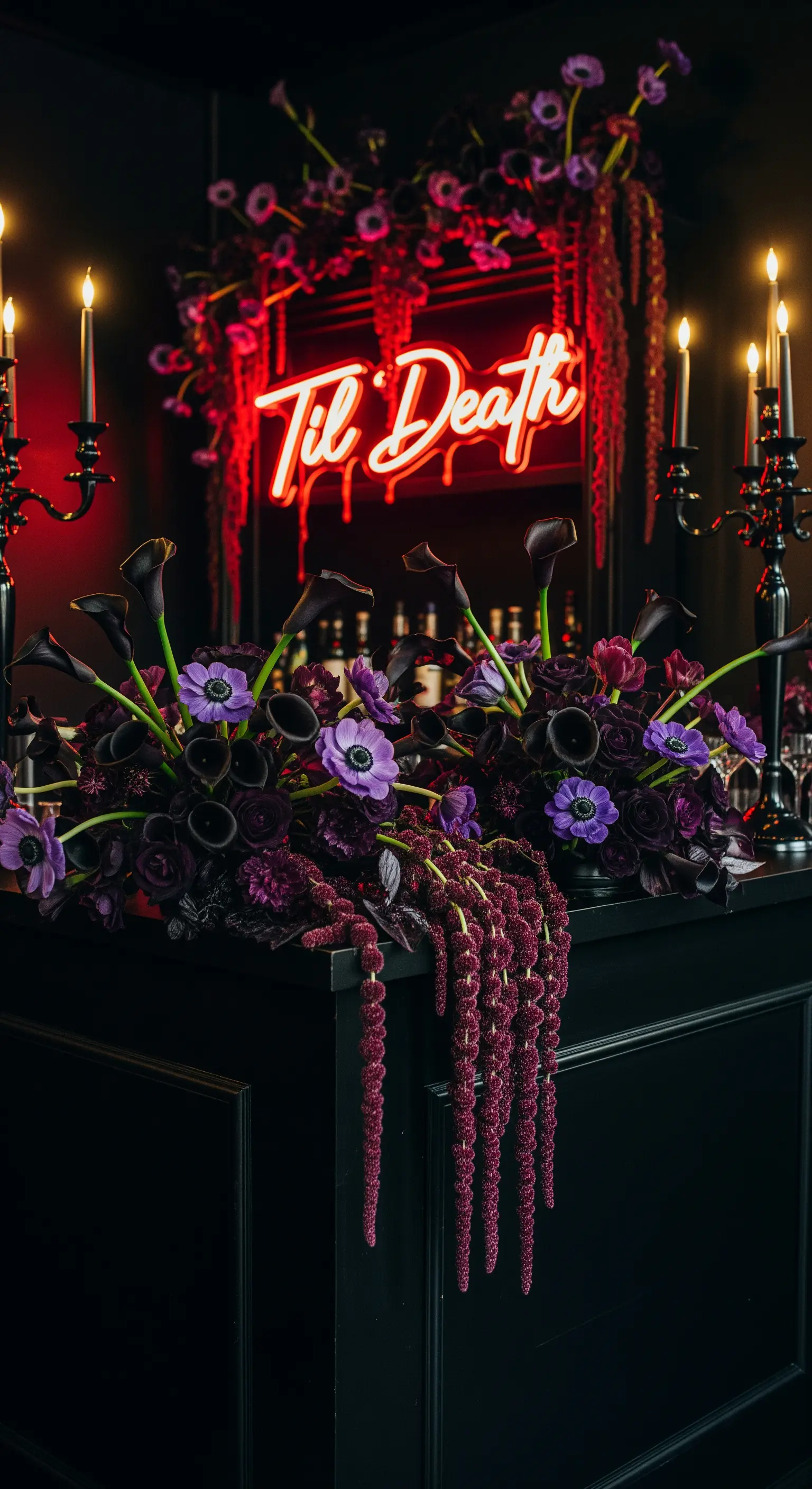 Bar nero con fiori viola scuro, candele nere e insegna 