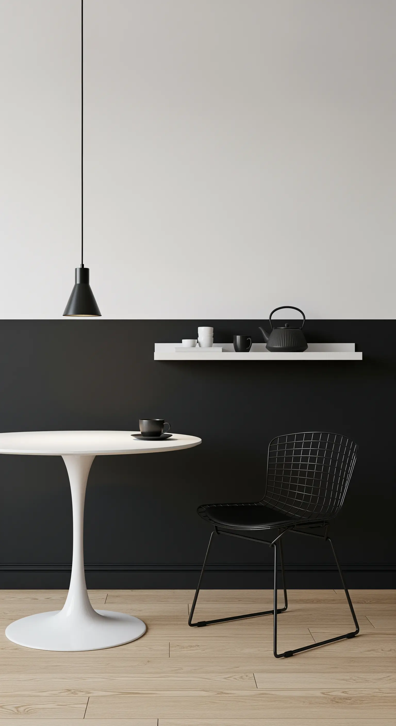 Angolo pranzo minimal con parete bicolore, tavolo bianco e sedia nera.