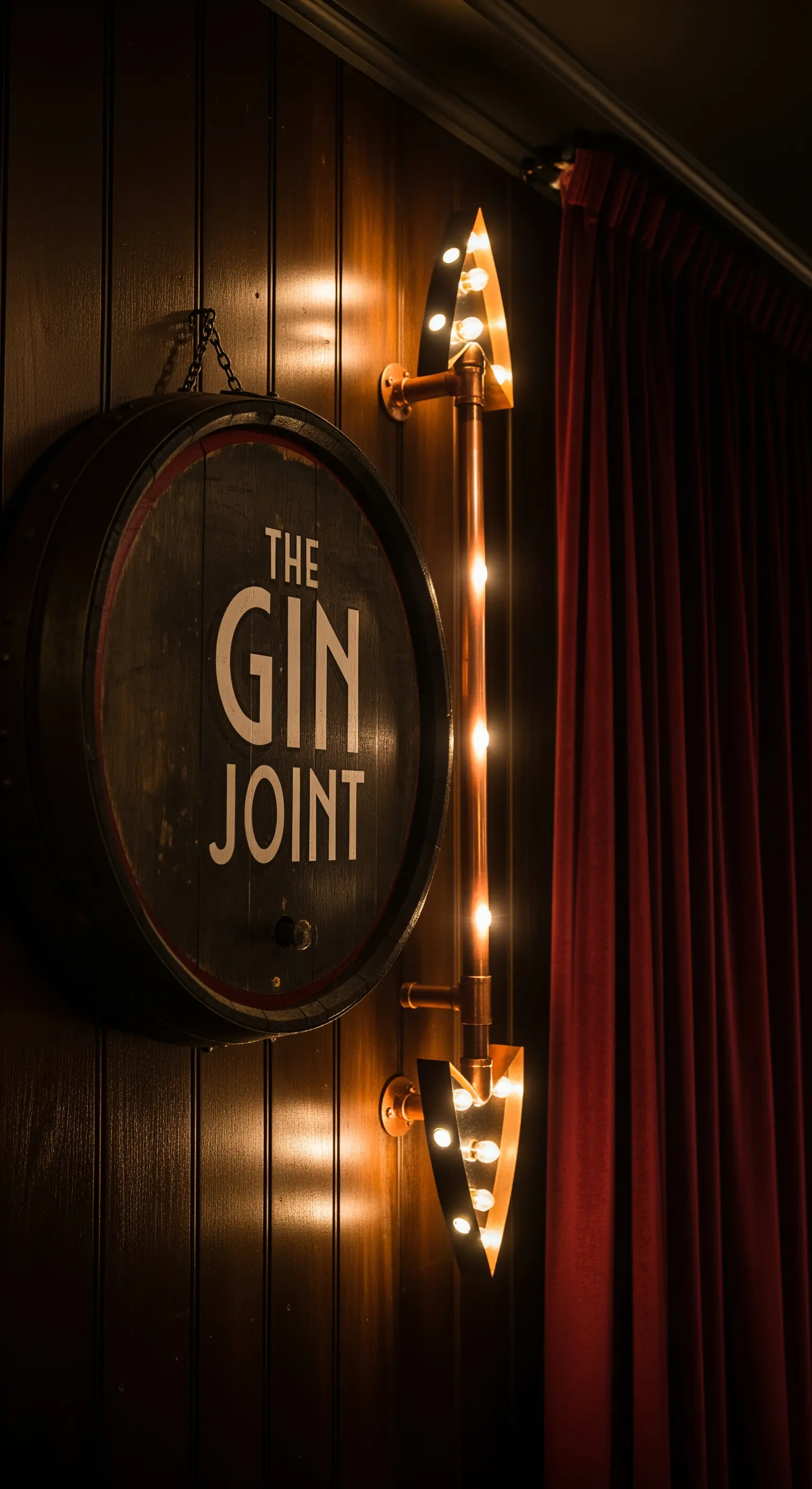 Insegna da bar rustica con coperchio di botte e applique a freccia in tubi di rame.